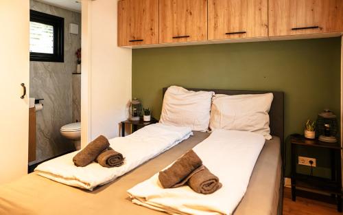 a bedroom with a bed with towels on it at Meikever in Putten