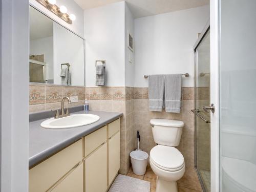 a bathroom with a toilet and a sink and a mirror at Golden Dream Studio 2nd floor B in Isabela