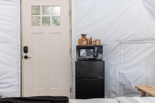 a white door and a black refrigerator in a room at Johnson Dome in Johnson
