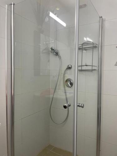 a shower stall with a glass door with a shower at 123Eilat panorama in Eilat