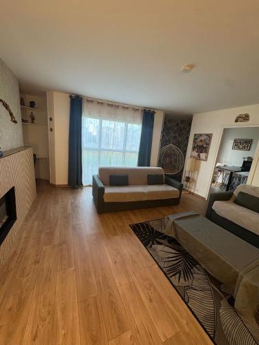 a living room with a couch and a fireplace at El Cubanito Athéna - Résidence de Standing - 2 Chambres - 4 Couchages - 8 Personnes Max - Parking Privé - Gare à 8 min in Cergy