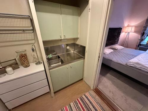 a small room with a bed and a small kitchen at Skolan - Boende Vindelälven in Gargnäs