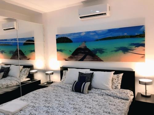 a bedroom with a bed and a large painting on the wall at Hotel Beach Pool Punta Cana Vacation in Punta Cana