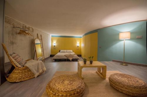 a bedroom with a bed and a chair and a table at Apartamento rural Castillo de Yeste 2 pax Especial Parejas in Yeste