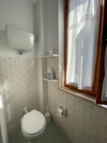 a small bathroom with a toilet and a window at ca' de Nardo in Tuoro sul Trasimeno