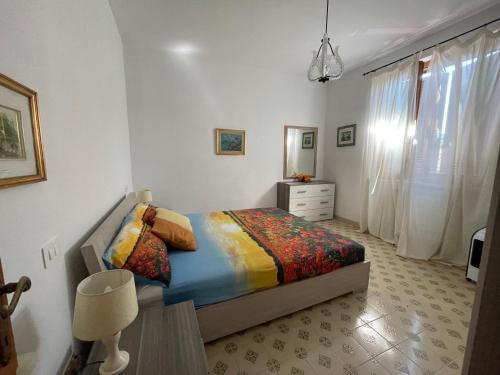 a bedroom with a bed and a dresser and a window at ca' de Nardo in Tuoro sul Trasimeno