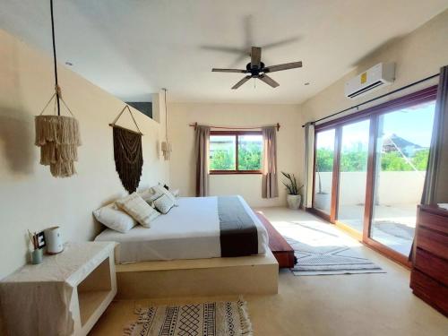 a bedroom with a bed and a ceiling fan at Private luxury villa in Holbox Island