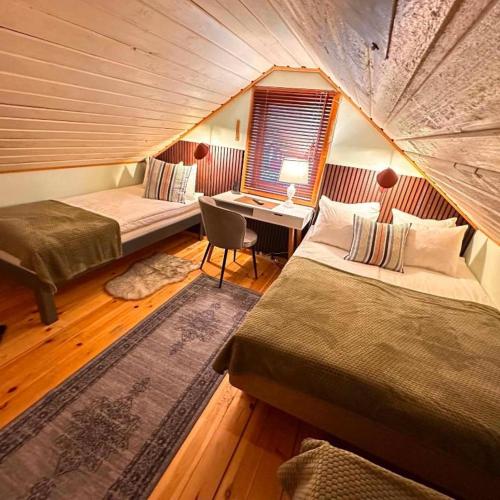 a room with two beds and a desk in a tent at Daltorps skola - self check in in Skövde