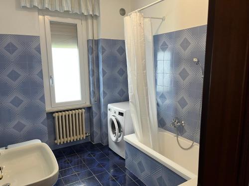 a bathroom with a sink and a toilet and a shower at Casa Antonio in Riva di Solto
