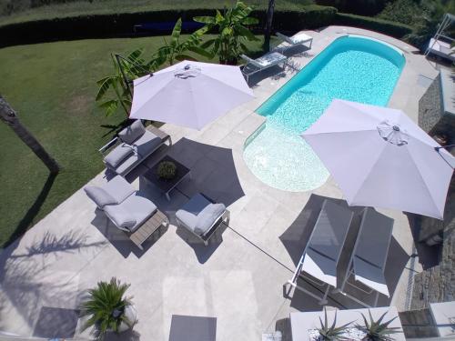 an overhead view of a pool with umbrellas and chairs at Vista Resort OPENING 13-7-26 in Albisola Superiore