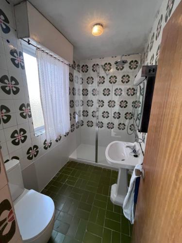 a bathroom with a toilet and a sink at Eclipse in Villasandino
