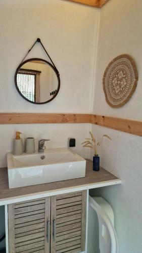 a bathroom with a sink and a mirror on the wall at Tente Lodge Logement Insolite 4pers Campagne Normande Orne in Ménil-Hubert-sur-Orne