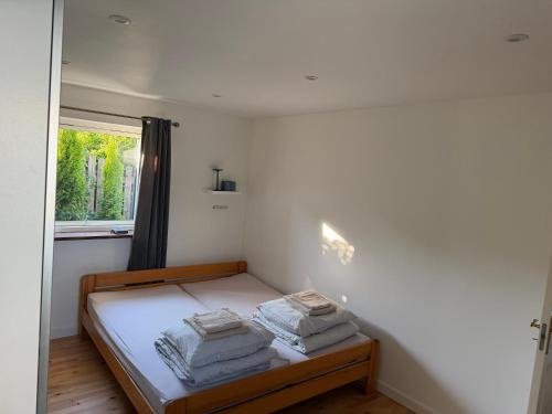 a bedroom with a bed with two pillows on it at Seaside Home in Fakse Ladeplads