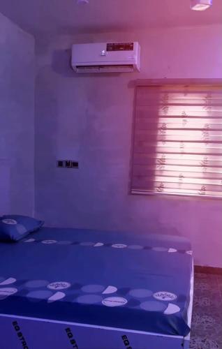 a bed in a room with a purple light at M & A Homes Ilorin in Ilorin