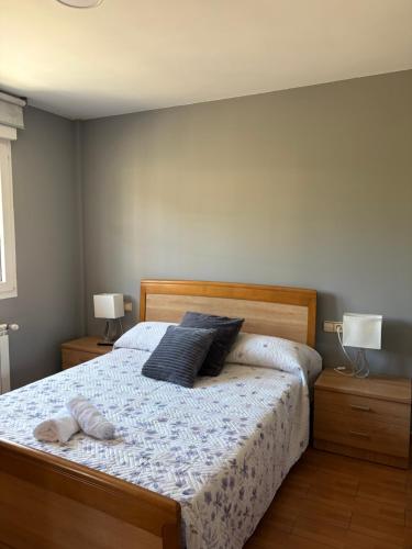 a bedroom with a bed with two pillows on it at Casa Mar de Neaño in Neaño