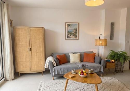 a living room with a blue couch and a table at Seaview.Cassis in Cassis