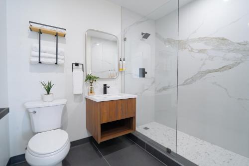 a bathroom with a toilet and a glass shower at Nox Hotel - Studio City in Studio City