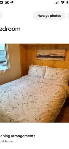 a bed in a room with avertisement at Clonvilla Mobile Chalet in Cromponn Bridge
