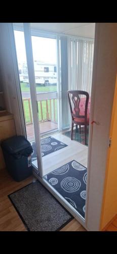 an open door to a room with a mirror at Clonvilla Mobile Chalet in Cromponn Bridge