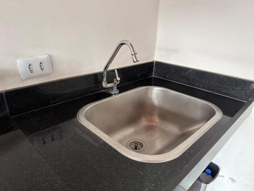 a kitchen sink with a faucet on a counter at Casa Dunas douradas in Barreirinhas