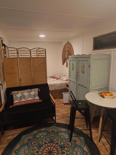 a room with a couch and a table and a bed at Rustika Tiny House in Pucón