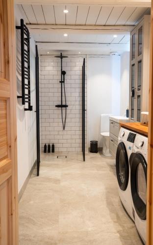 a laundry room with a washer and dryer at Almeboda in Österlen in Östra Hoby