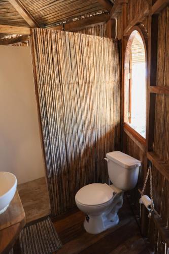 a bathroom with a toilet and a sink at Adama Eco Farm in Santa Catalina