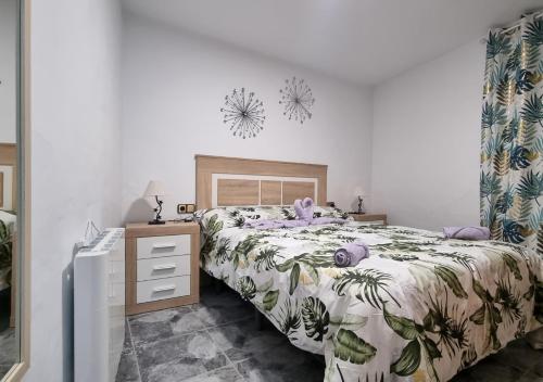 a bedroom with a large bed and a dresser at Gran Areatxa Home Mountain in Santiago de la Espada