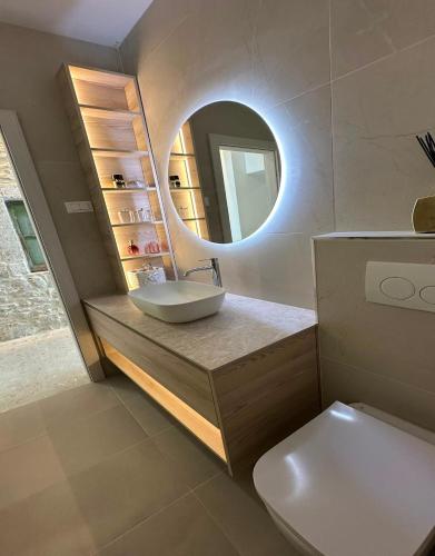 a bathroom with a sink and a mirror at Apartment Dolce by DuBooker in Trpanj