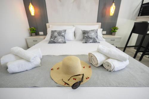 a bedroom with a bed with a hat and towels at Esmeralda Guest House in Cinisi