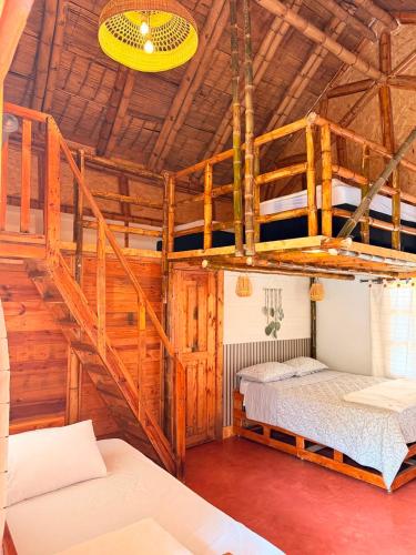 a room with two bunk beds and a staircase at Hotel Campestre Campos Verdes in Roldanillo