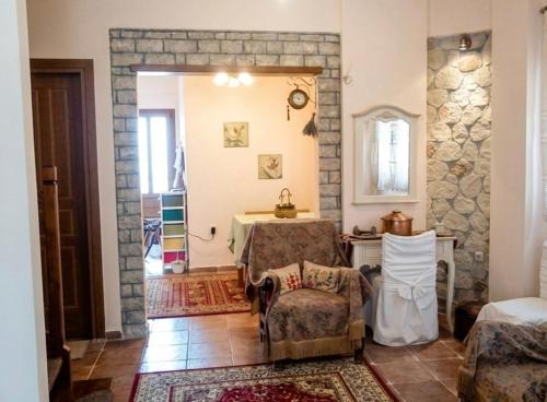 a living room with a table and a chair at Dreamcatcher Maisonette No.2 in Kalavrita