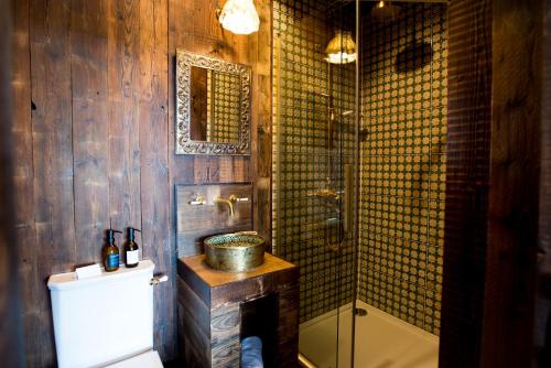 a bathroom with a shower and a sink and a toilet at Oak - The Nook Lodges in Wrenbury