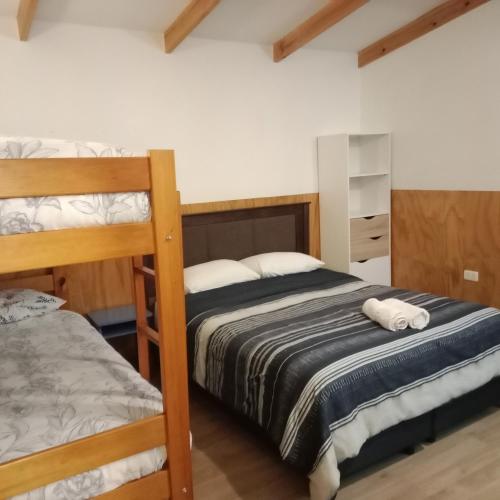a bedroom with two bunk beds and a closet at Ruta 7 in Coihaique