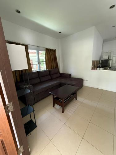 a living room with a couch and a coffee table at olivia village pool resort in Mae Nam