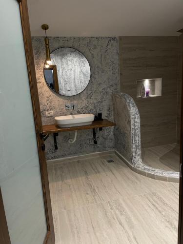 a bathroom with a sink and a mirror at Villa Monte Shpirag in Berat