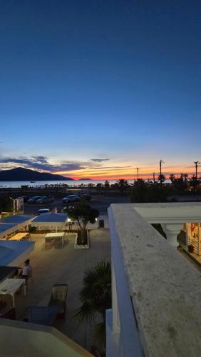 a view of a sunset from a balcony of a building at Onde Rooms in Vlorë