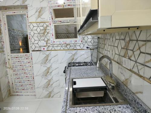 a kitchen with a sink and a counter top at Holiday Home Matrouh in Marsa Matruh