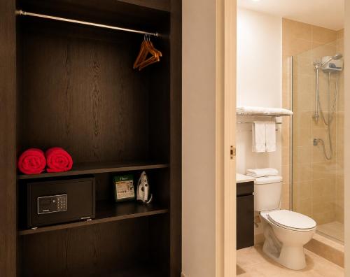 a bathroom with a toilet and a shower at Ladybugs Apartments in Palm-Eagle Beach