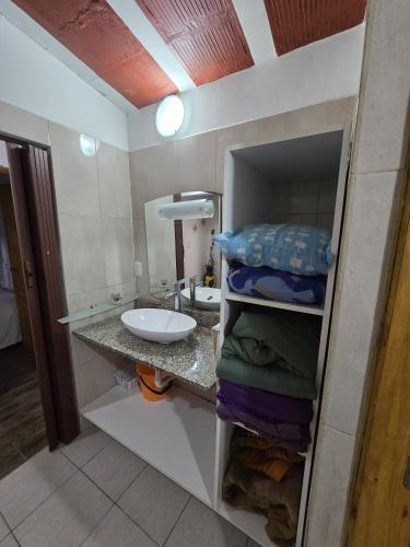 a bathroom with a sink and a counter with towels at La Chiquitita in Villa Dolores