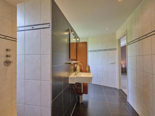a bathroom with a sink and a mirror at Laurahoeve in Nederweert