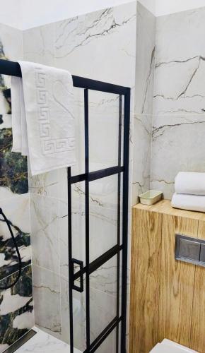a bathroom with a towel hanging on a wall at BOOGIE Home Nawrot 13 in Łódź