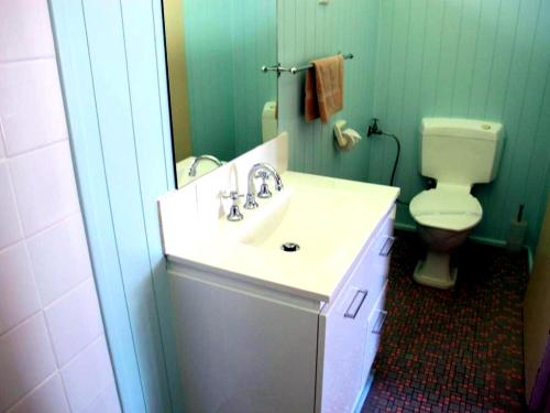 a bathroom with a sink and a toilet at Merimbula Coastline Motel in Merimbula