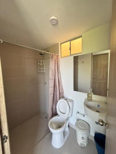 a bathroom with a toilet and a sink at Aparta Hotel Casacrislaye Santa marta in Santa Marta