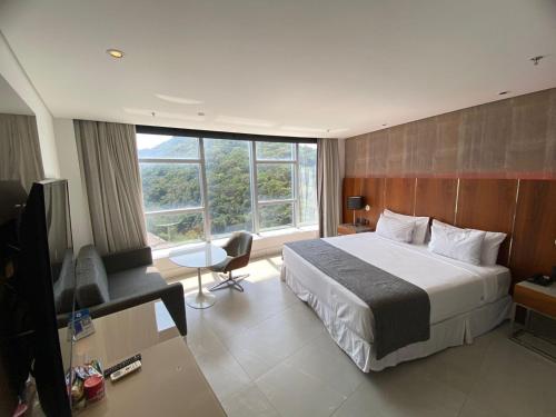 a hotel room with a bed and a television at Icônico Hotel Nacional in Rio de Janeiro