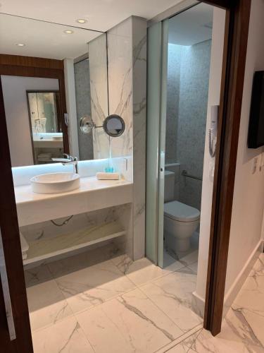 a bathroom with a sink and a toilet at Icônico Hotel Nacional in Rio de Janeiro