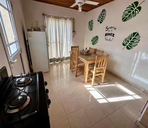 a kitchen with a table and chairs and a refrigerator at Departamento Jumace in Federación