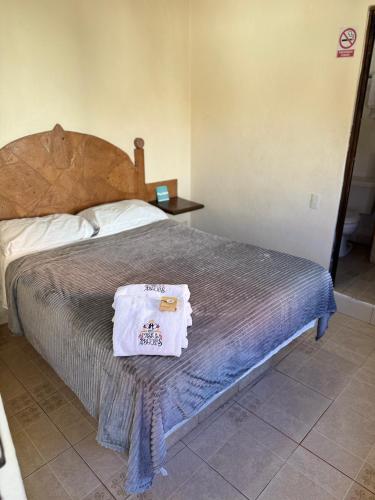 a bedroom with a bed with a white towel on it at Hotel Casa de Los Abuelos in Bernal