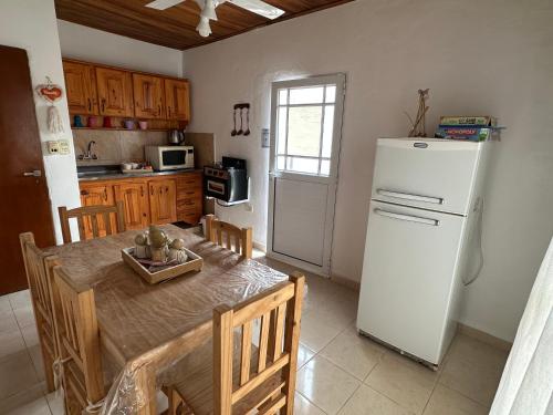 a kitchen with a table and a white refrigerator at Departamento Jumace in Federación