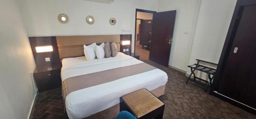 a bedroom with a large bed in a hotel room at SR Hotel in Salalah